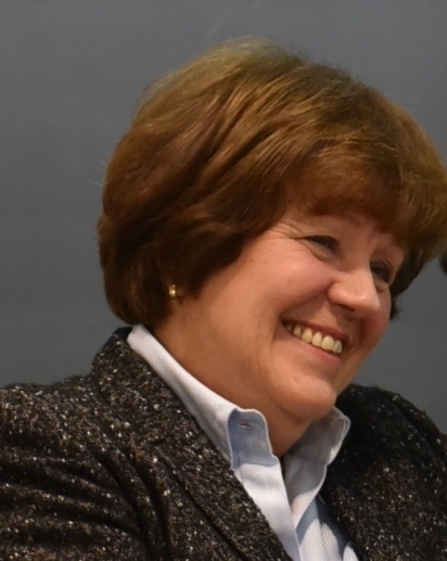 a side-view portrait photo of linda fowler smiling